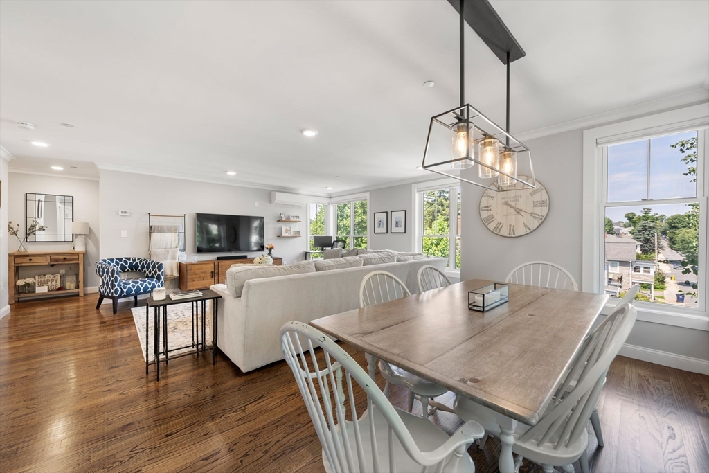 1789 Centre Street, Unit 401 Boston, MA 02132 - Photo 9 of 30 a view of a dining room with furniture a chandelier and wooden floor