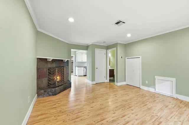 a kitchen with a sink cabinets and wooden floor