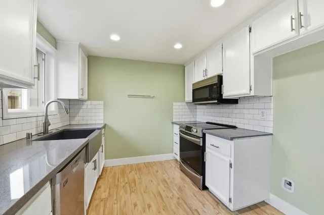 a kitchen with a sink and cabinets