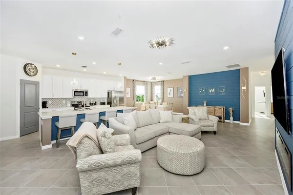 a living room with furniture and a large mirror