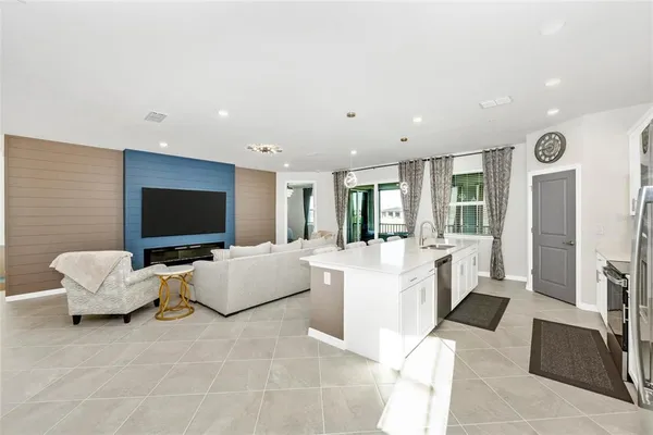 a kitchen with a refrigerator a table and chairs in it