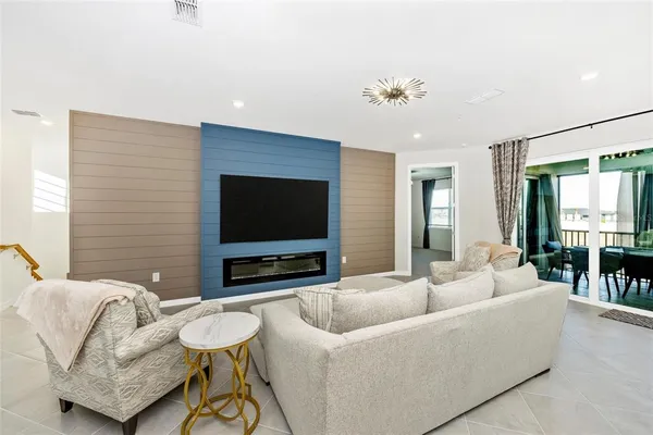 a kitchen with stainless steel appliances a table chairs microwave and cabinets
