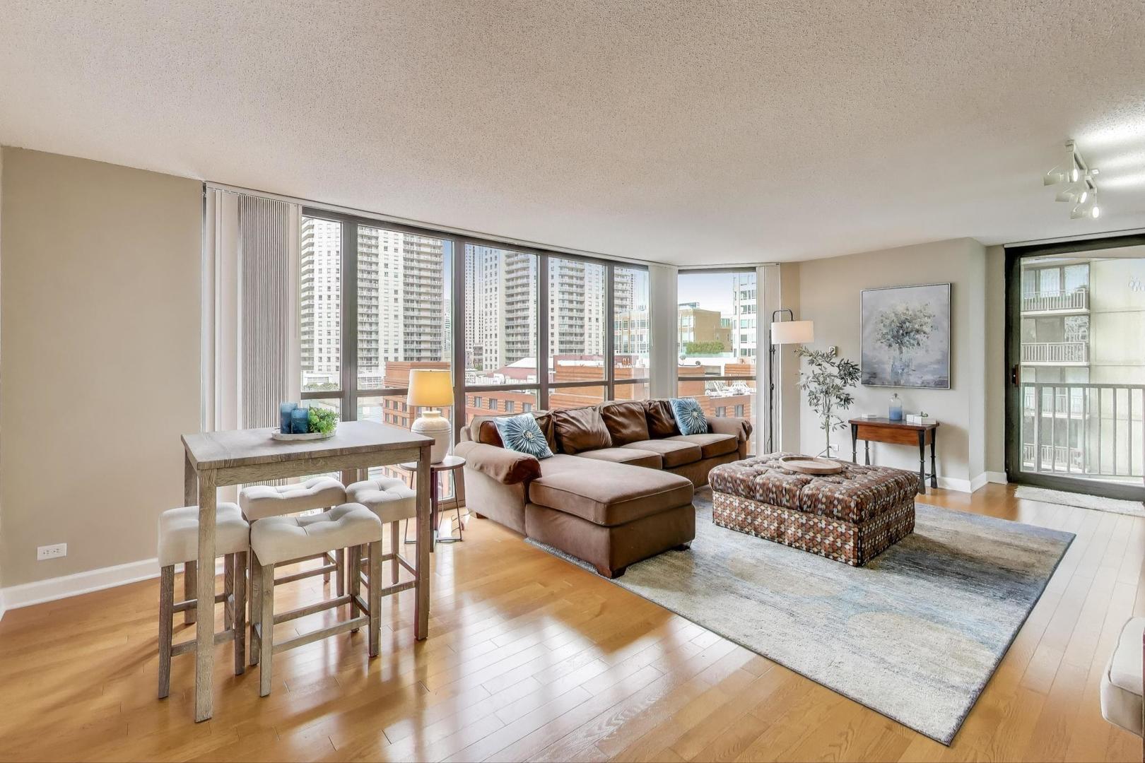 10 East Ontario Street, Unit 1205 Chicago, IL 60611 - Photo 6 of 30 a living room with furniture and a large window