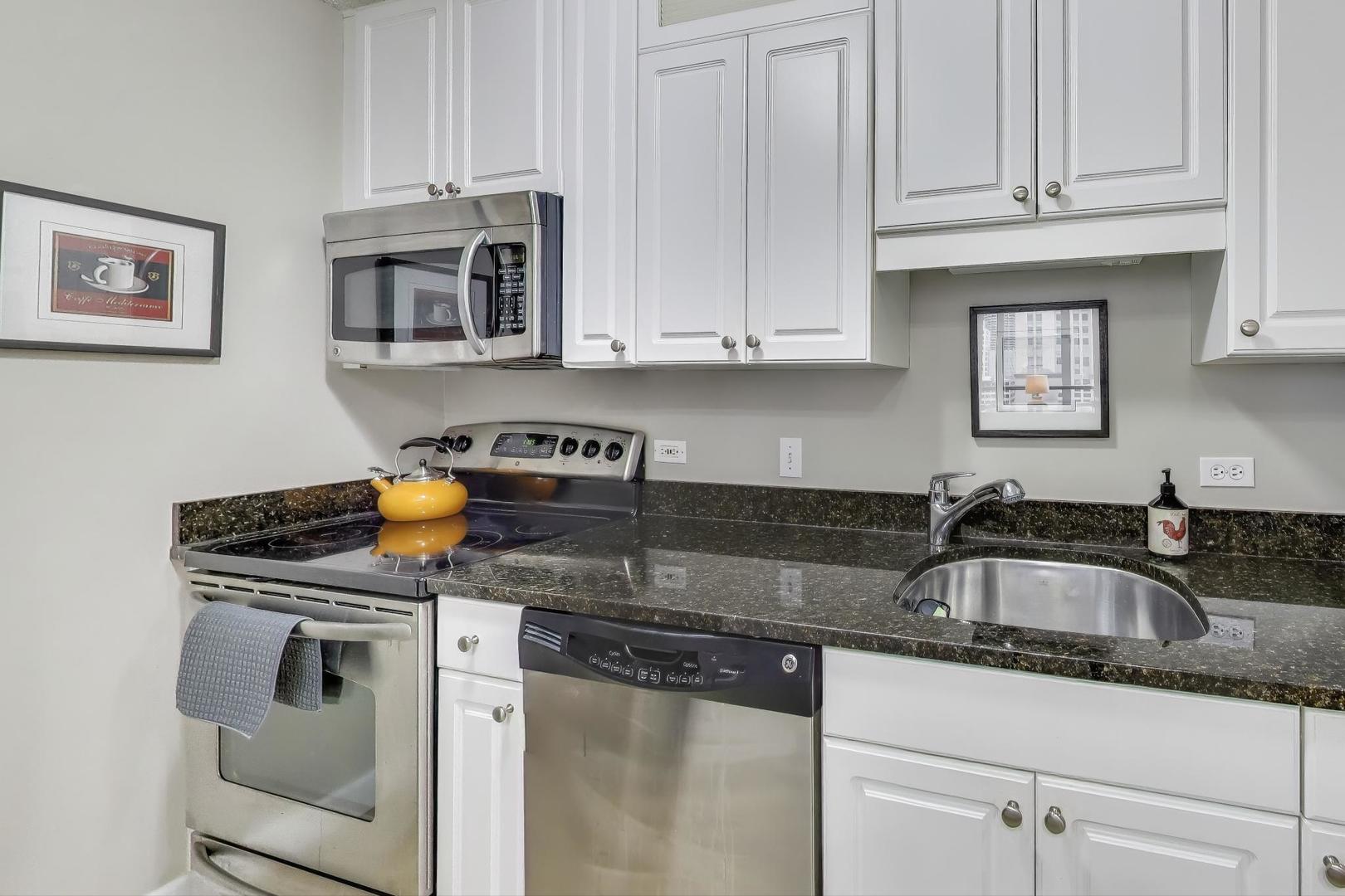 10 East Ontario Street, Unit 1205 Chicago, IL 60611 - Photo 8 of 30 a kitchen with stainless steel appliances granite countertop a sink stove and cabinets