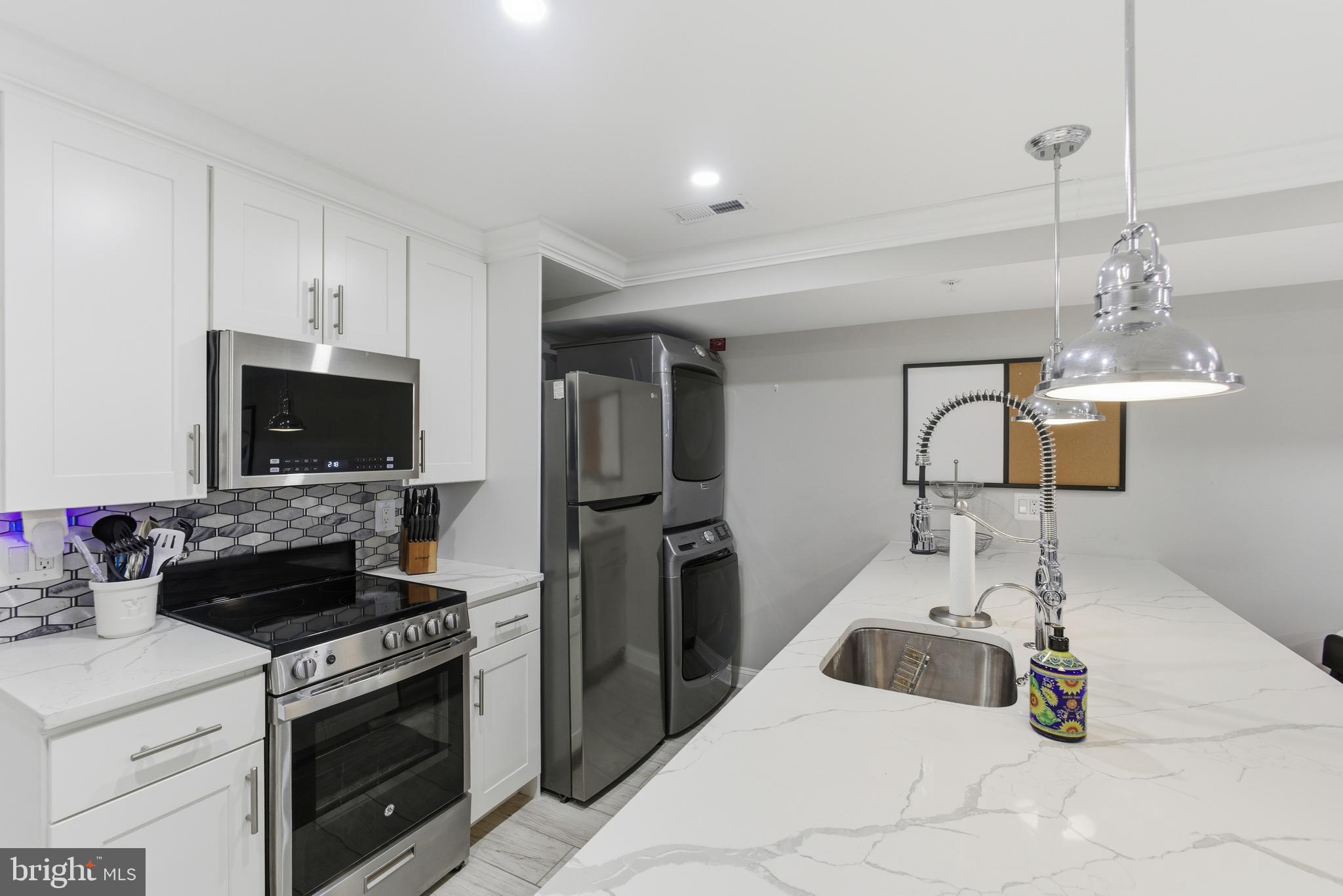 1748 S Street Northwest, Unit 2 Washington, DC 20009 - Photo 14 of 33 a kitchen with a stove and a sink