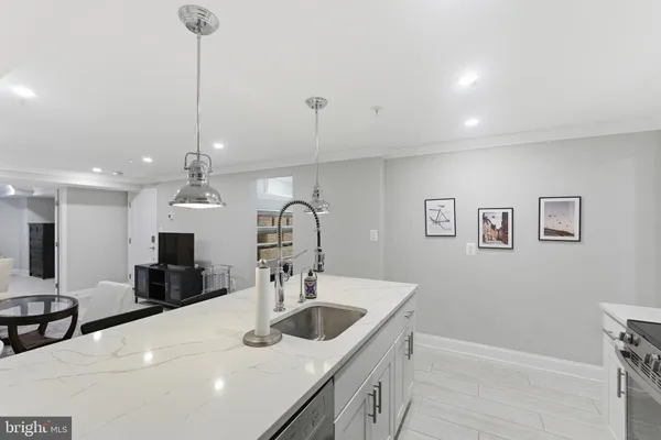 a kitchen with center island a sink stainless steel appliances and cabinets