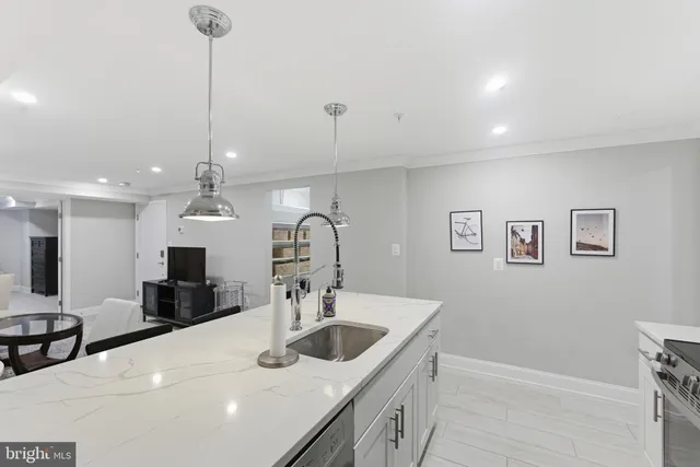 a kitchen with center island a sink stainless steel appliances and cabinets