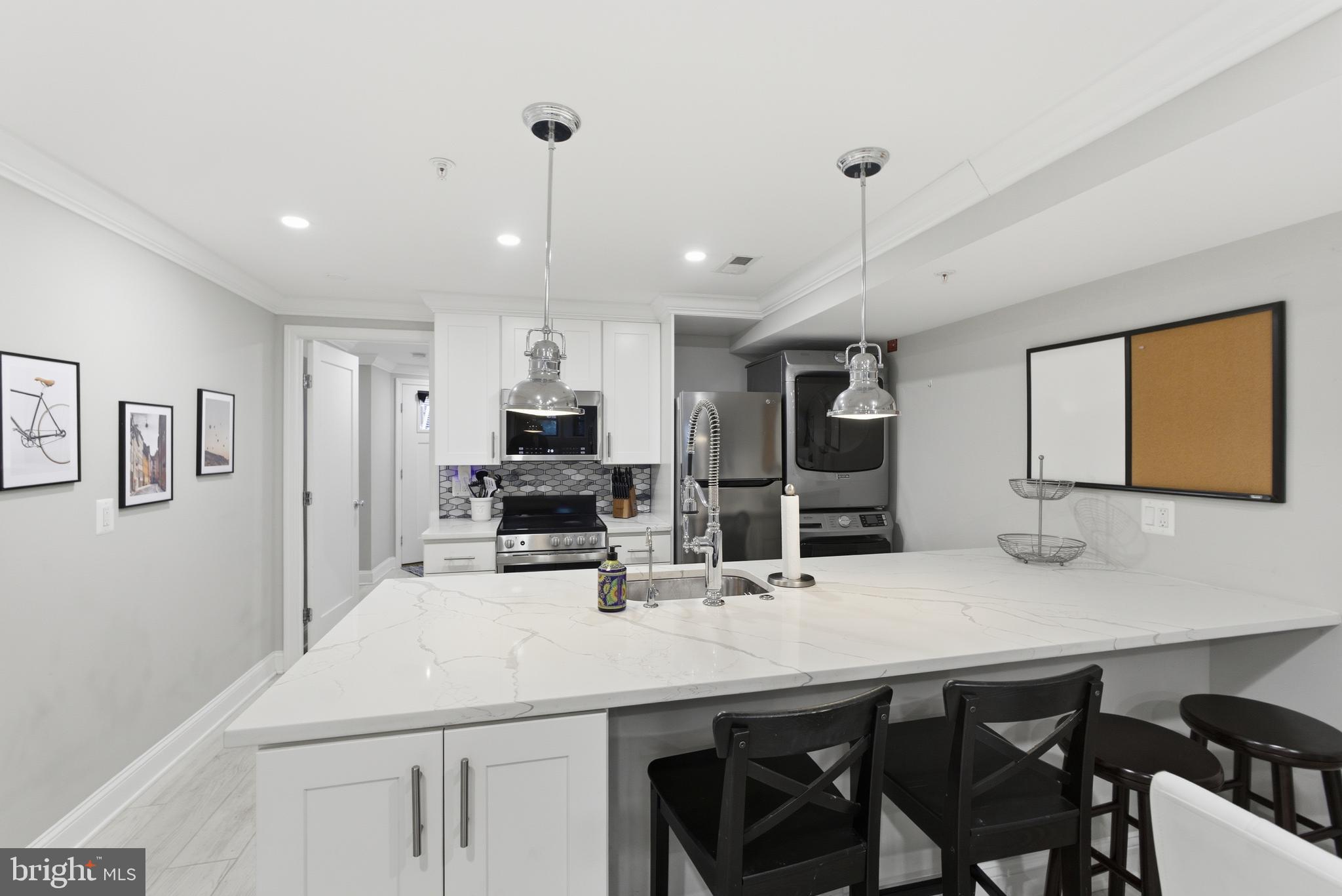 1748 S Street Northwest, Unit 2 Washington, DC 20009 - Photo 16 of 33 a kitchen with cabinets a sink and chairs