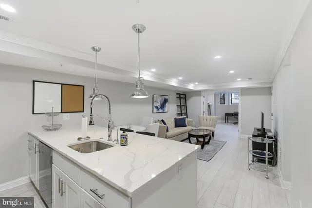 a large kitchen with a large counter top appliances and furniture