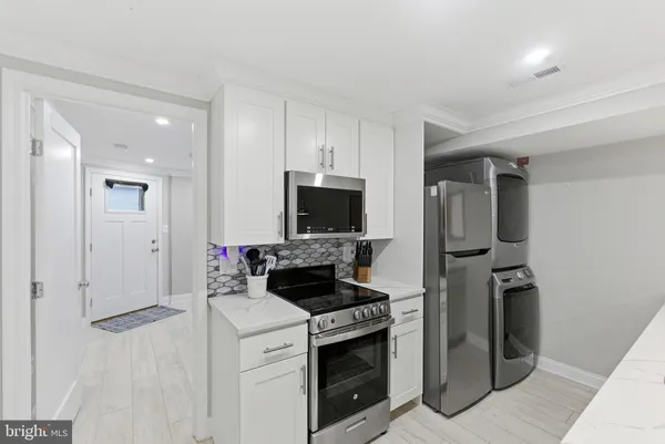 a kitchen with a stove and a refrigerator