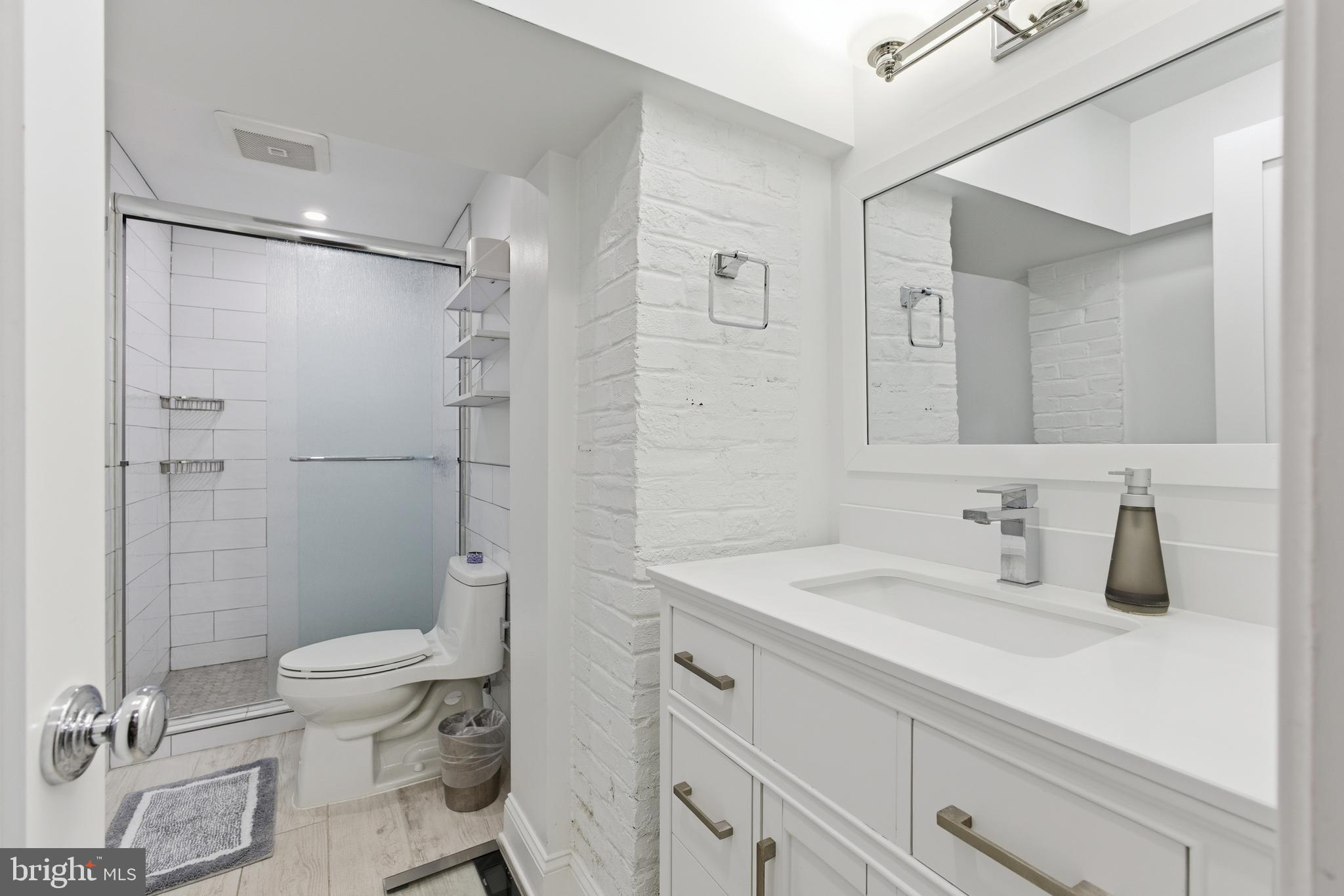 1748 S Street Northwest, Unit 2 Washington, DC 20009 - Photo 22 of 33 a bathroom with a sink a toilet and shower