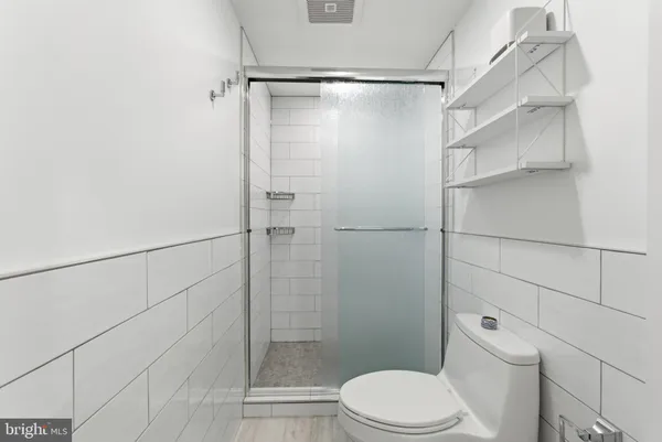 a bathroom with a toilet and shower