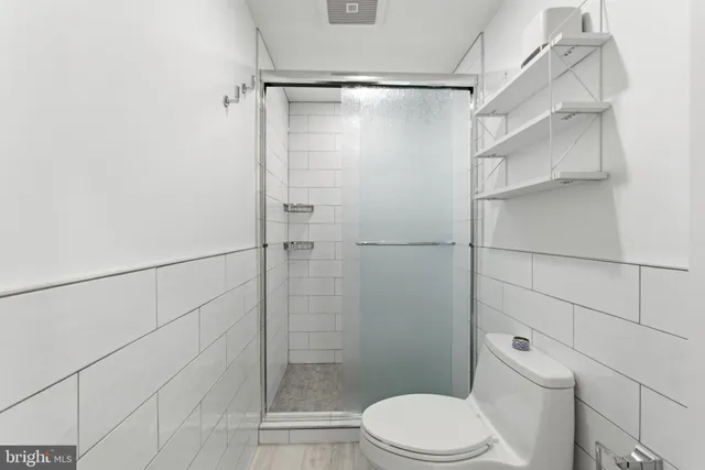 a bathroom with a toilet and shower