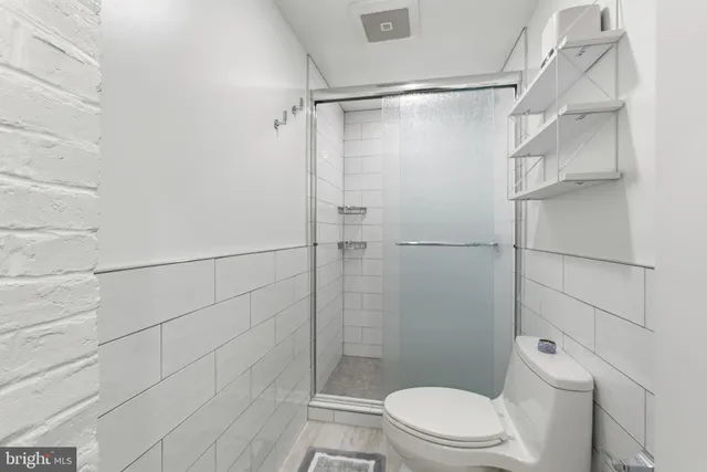 a bathroom with a toilet and shower