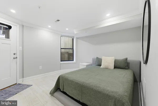 a bedroom with a large bed and a ceiling fan