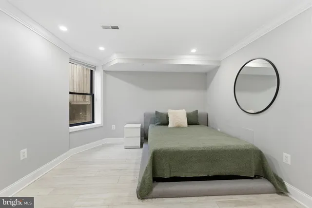 a bedroom with a large bed and a mirror