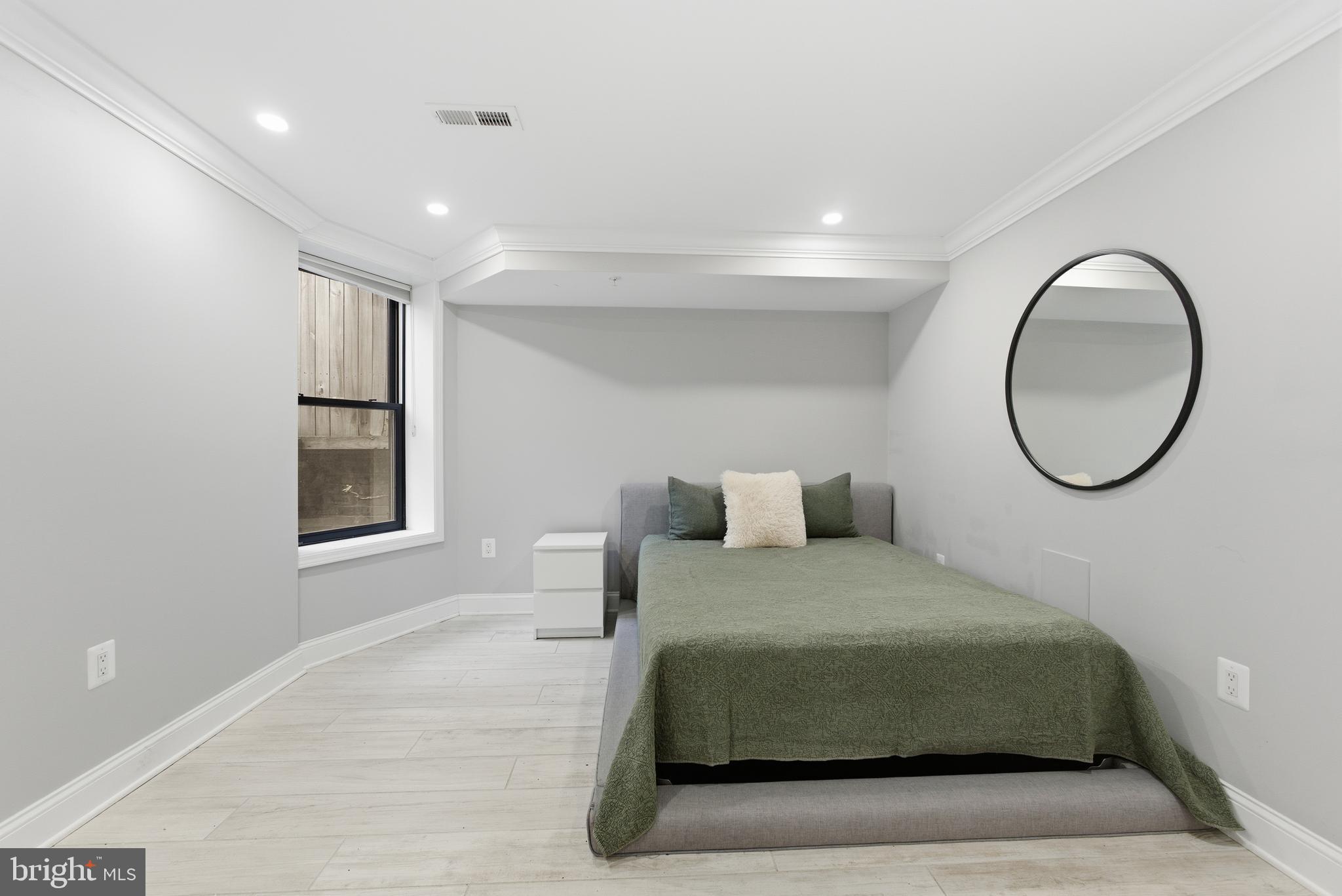 1748 S Street Northwest, Unit 2 Washington, DC 20009 - Photo 30 of 33 a bedroom with a large bed and a mirror