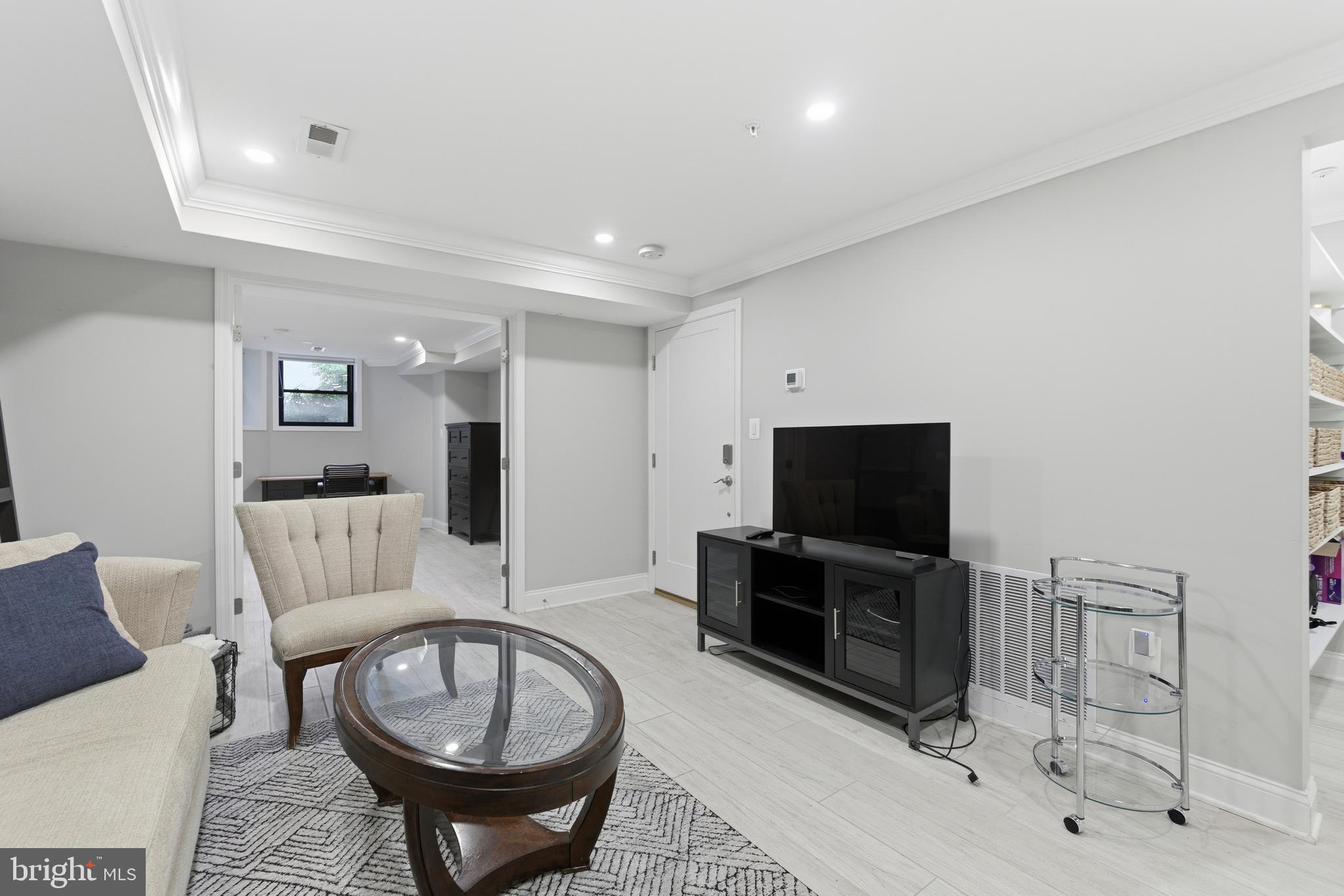 1748 S Street Northwest, Unit 2 Washington, DC 20009 - Photo 3 of 33 a living room with furniture and a flat screen tv