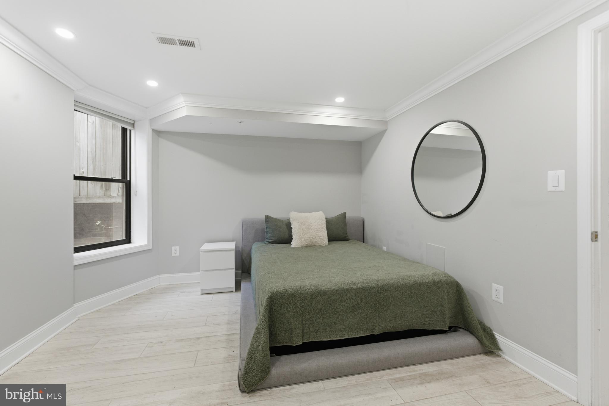 1748 S Street Northwest, Unit 2 Washington, DC 20009 - Photo 31 of 33 a bedroom with a bed and a painting on the wall