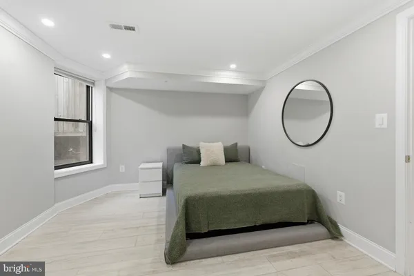 a bedroom with a bed and a window