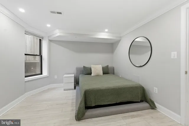 a bedroom with a bed and a window