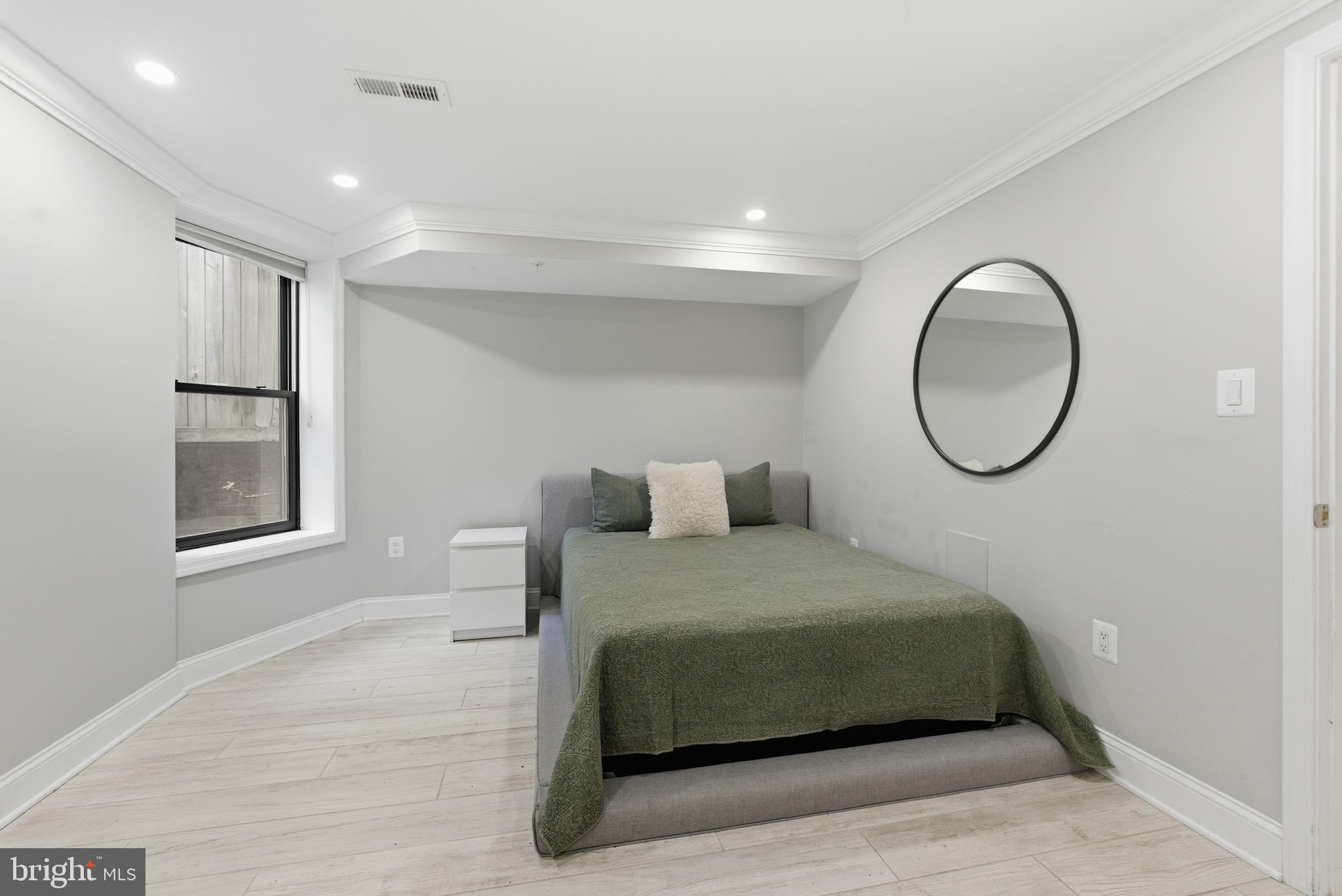 1748 S Street Northwest, Unit 2 Washington, DC 20009 - Photo 32 of 33 a bedroom with a bed and a window