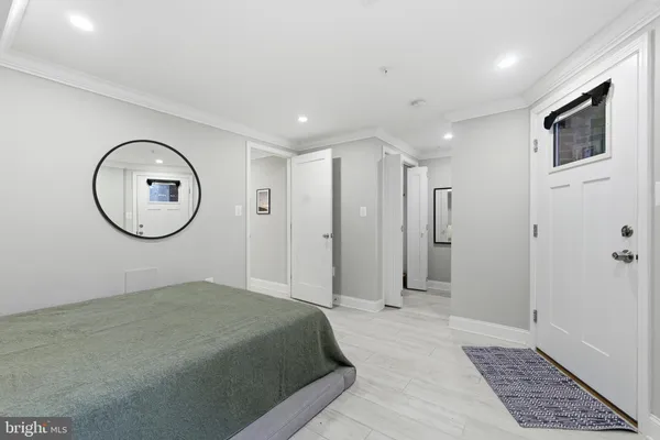 a view of a room with wooden floor and white walls