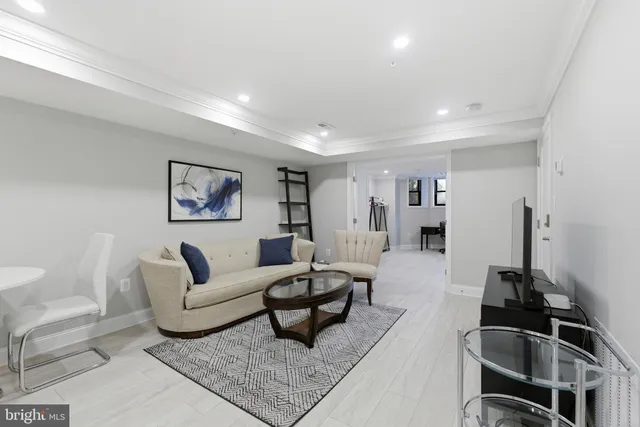 a living room with furniture and a rug