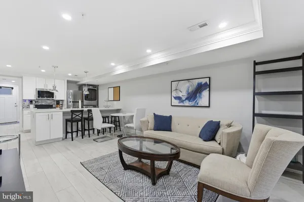 a living room with furniture kitchen view and a dining table