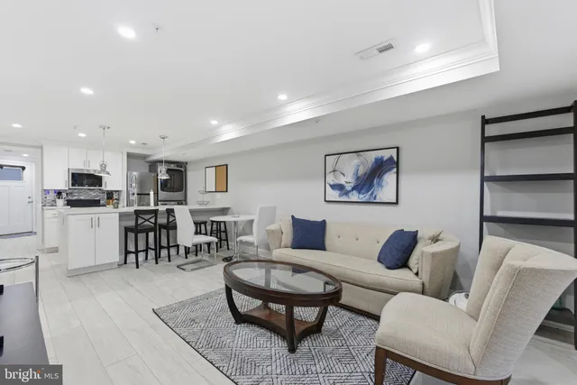 a living room with furniture kitchen view and a dining table