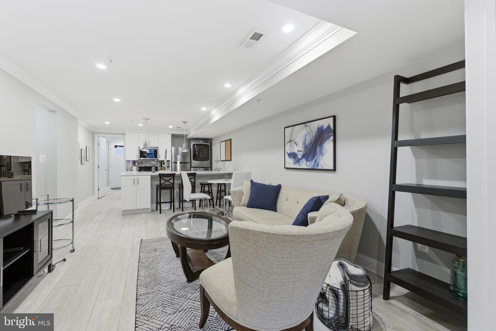 1748 S Street Northwest, Unit 2 Washington, DC 20009 - Photo 6 of 33 a living room with stainless steel appliances furniture a rug and a kitchen view