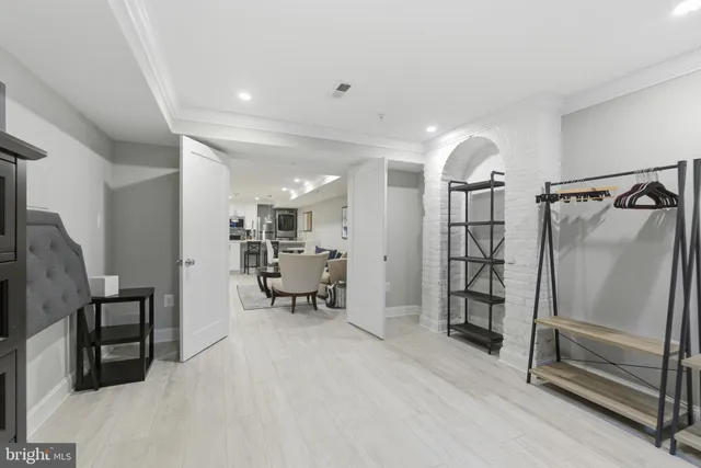 a view of a hallway with workspace and furniture