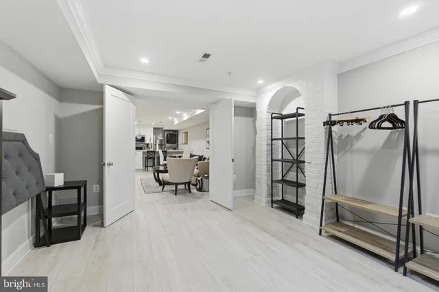 a view of a hallway with workspace and a window