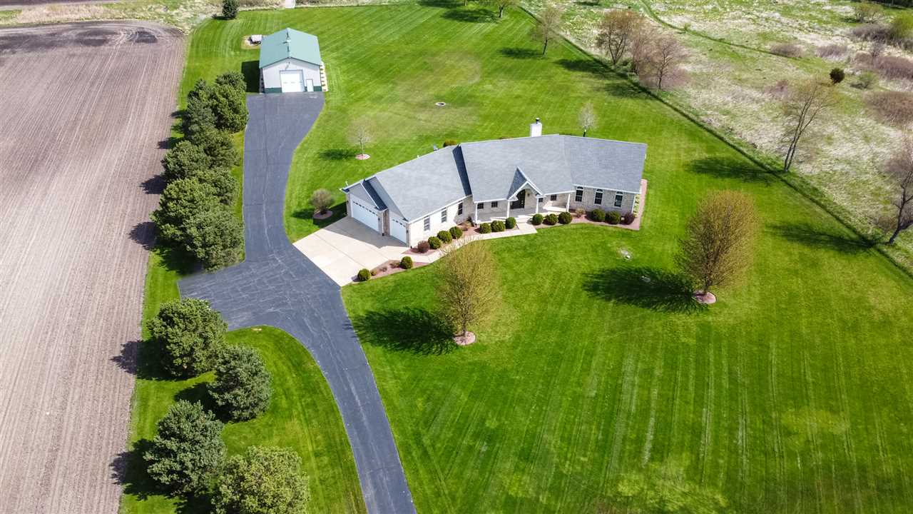 an aerial view of a house with a yard
