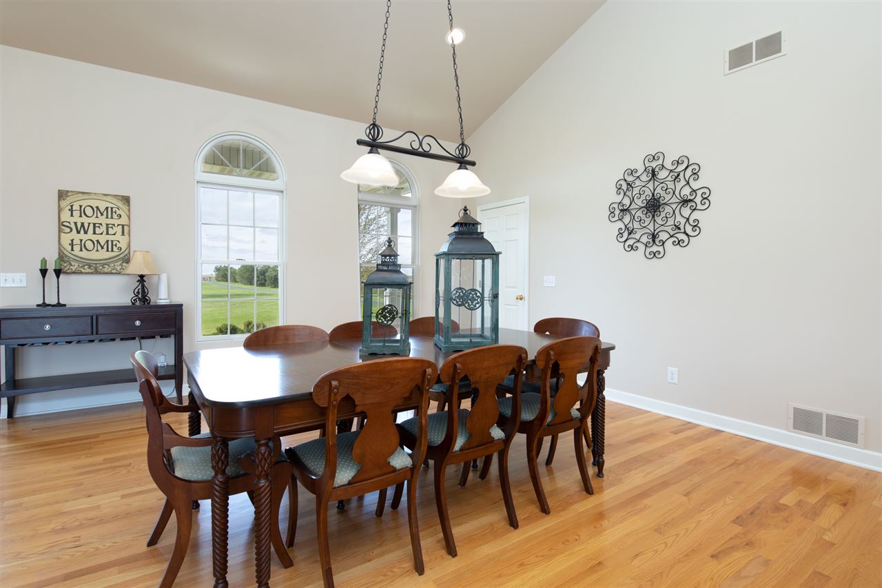 6300 Quail Trap Road Poplar Grove, IL 61065 - Photo 12 of 34 a view of a dining room with furniture window and wooden floor