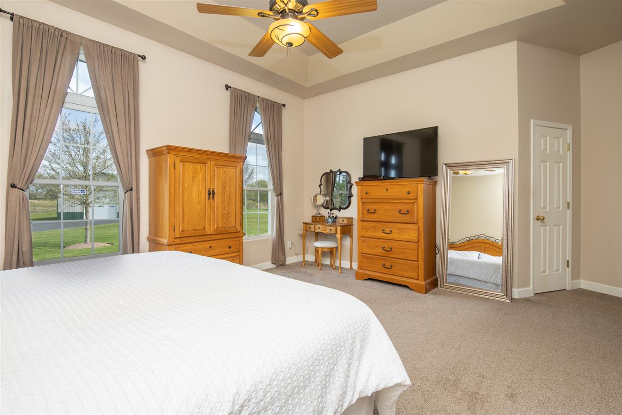 6300 Quail Trap Road Poplar Grove, IL 61065 - Photo 17 of 34 a bedroom with a bed and a dresser