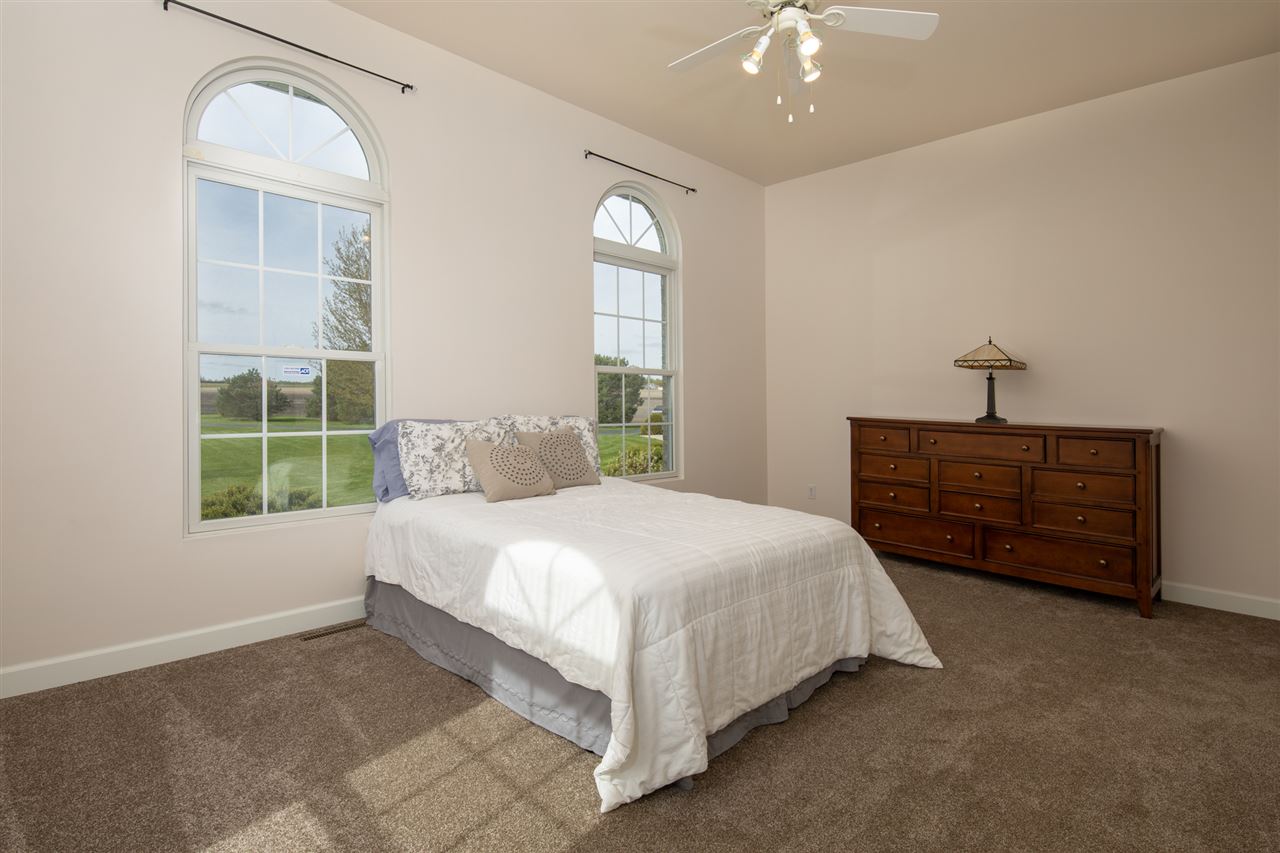 6300 Quail Trap Road Poplar Grove, IL 61065 - Photo 19 of 34 a bedroom with a bed dresser and a window