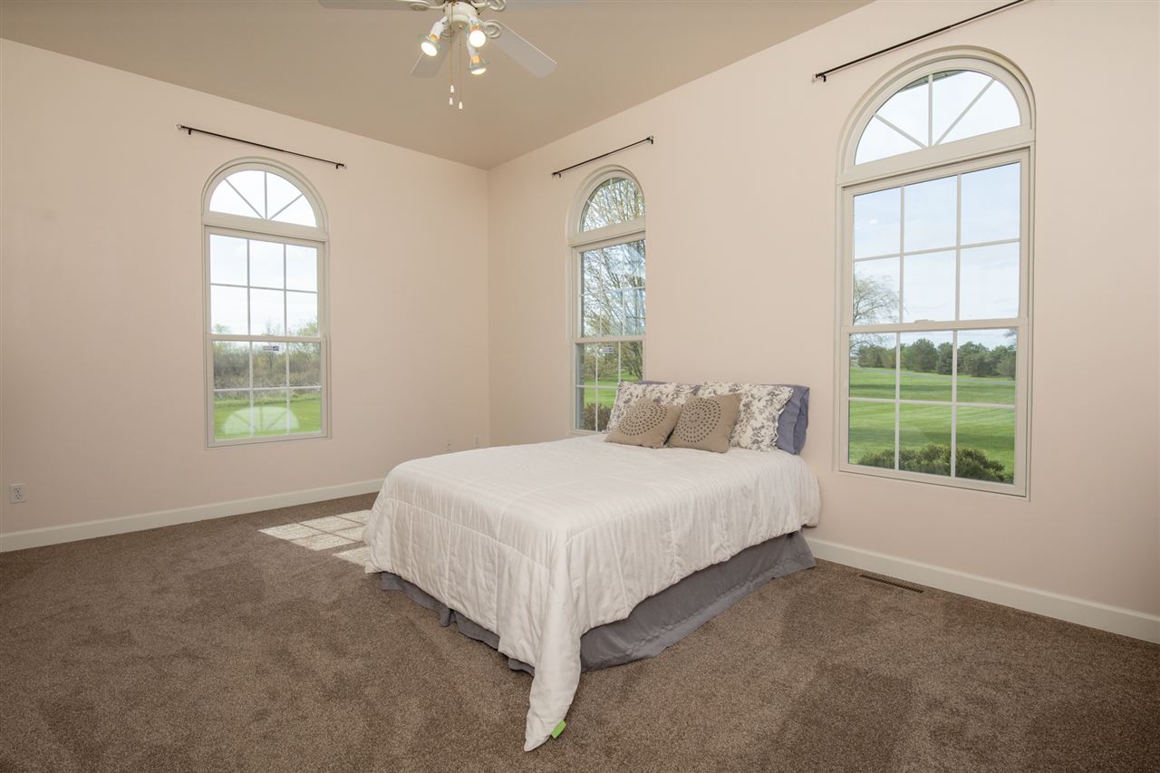 6300 Quail Trap Road Poplar Grove, IL 61065 - Photo 20 of 34 a bedroom with a bed and a window