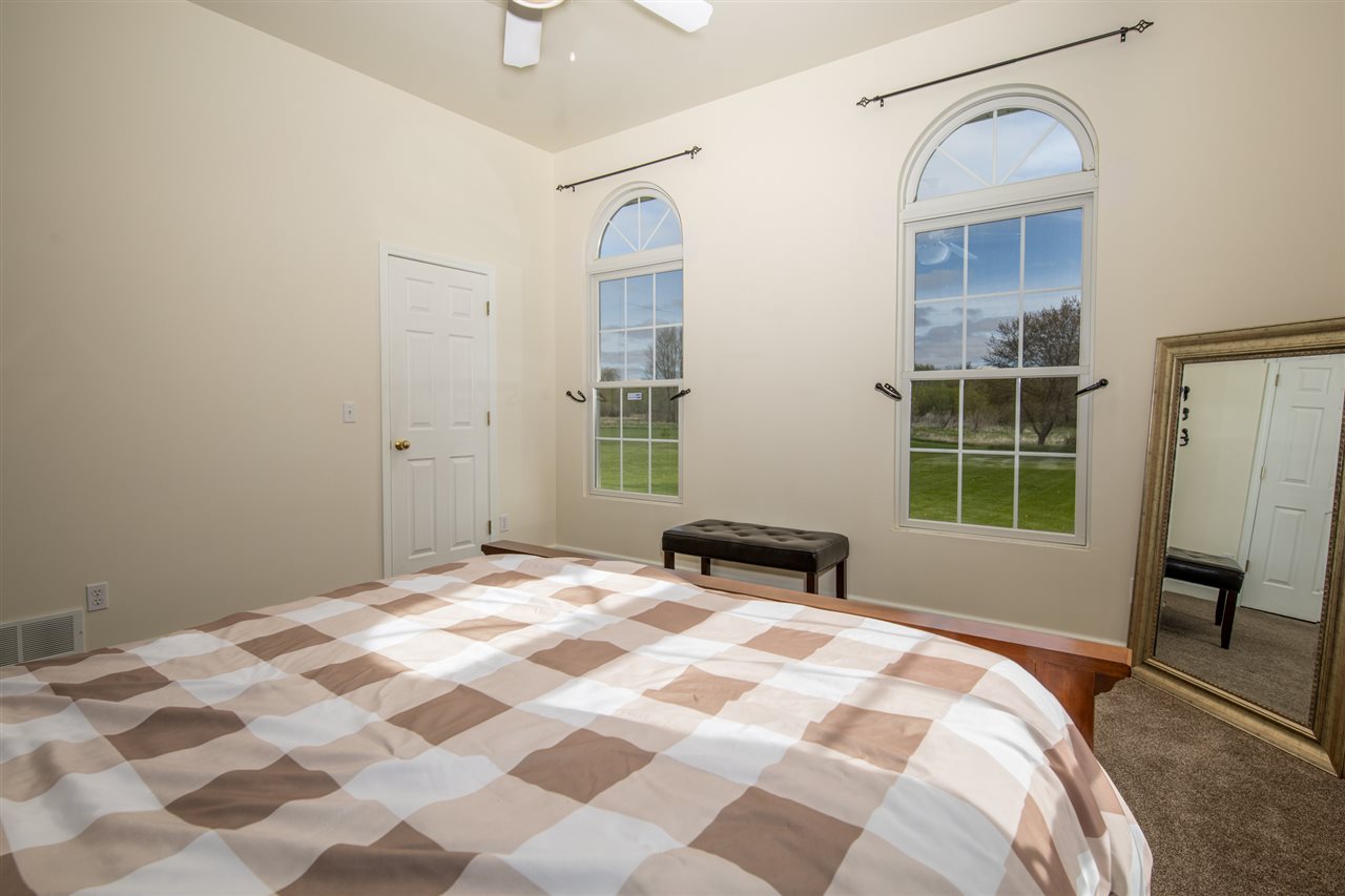 6300 Quail Trap Road Poplar Grove, IL 61065 - Photo 22 of 34 a bedroom with a bed and a window