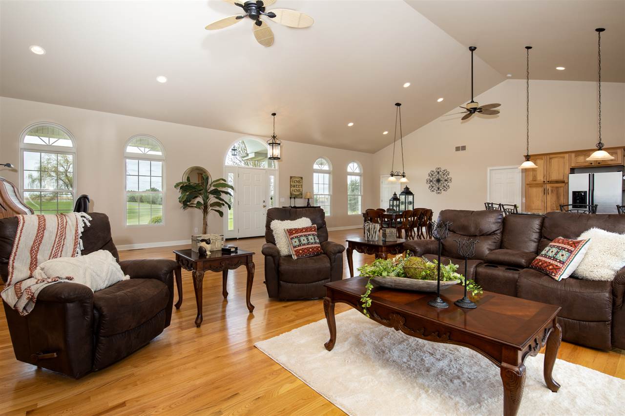 6300 Quail Trap Road Poplar Grove, IL 61065 - Photo 8 of 34 a living room with furniture kitchen area and a chandelier