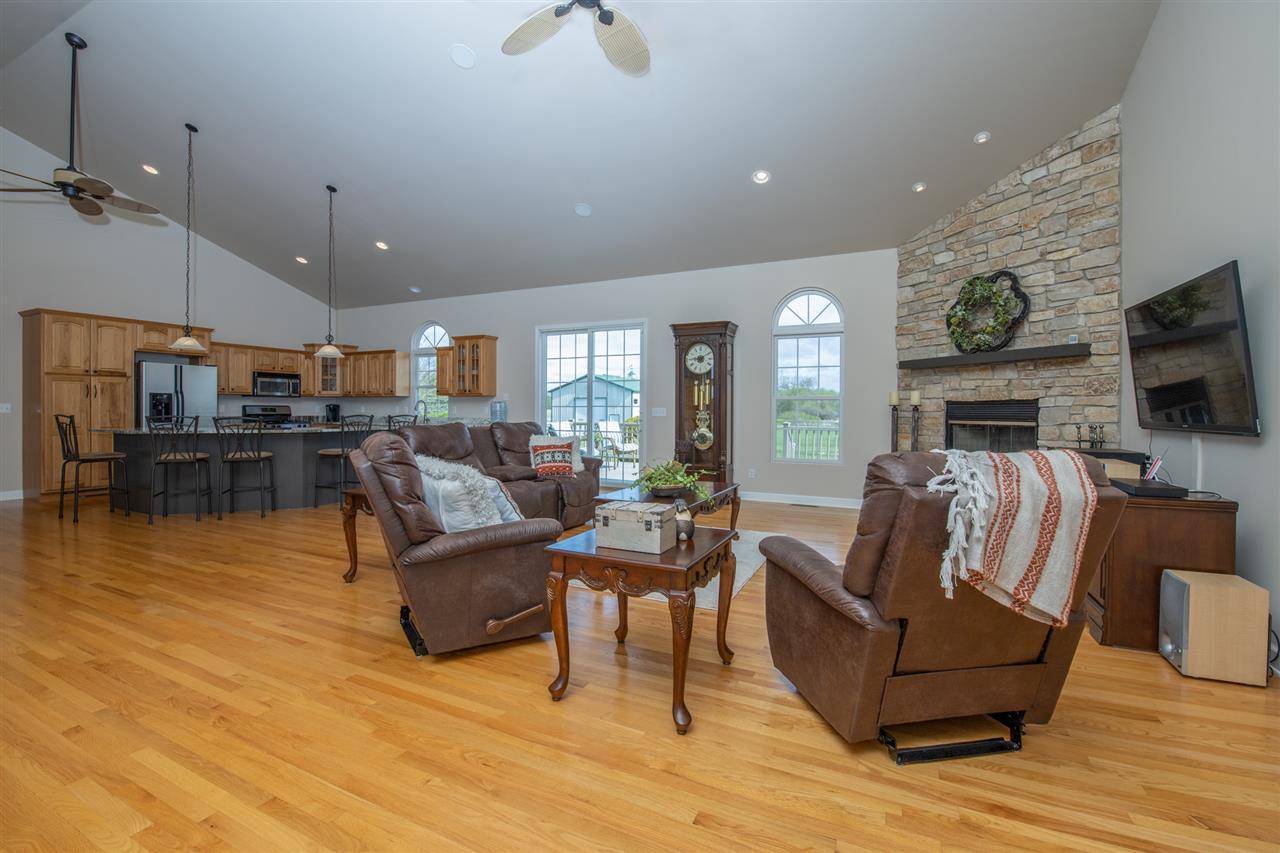 6300 Quail Trap Road Poplar Grove, IL 61065 - Photo 10 of 34 a living room with fireplace furniture and a flat screen tv