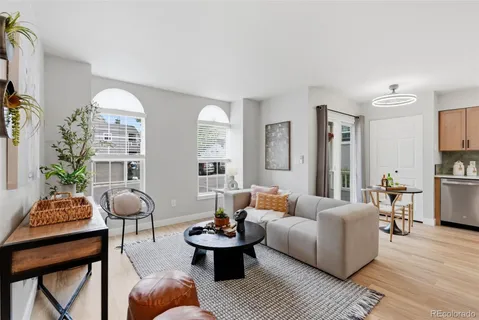 a living room with furniture and kitchen view