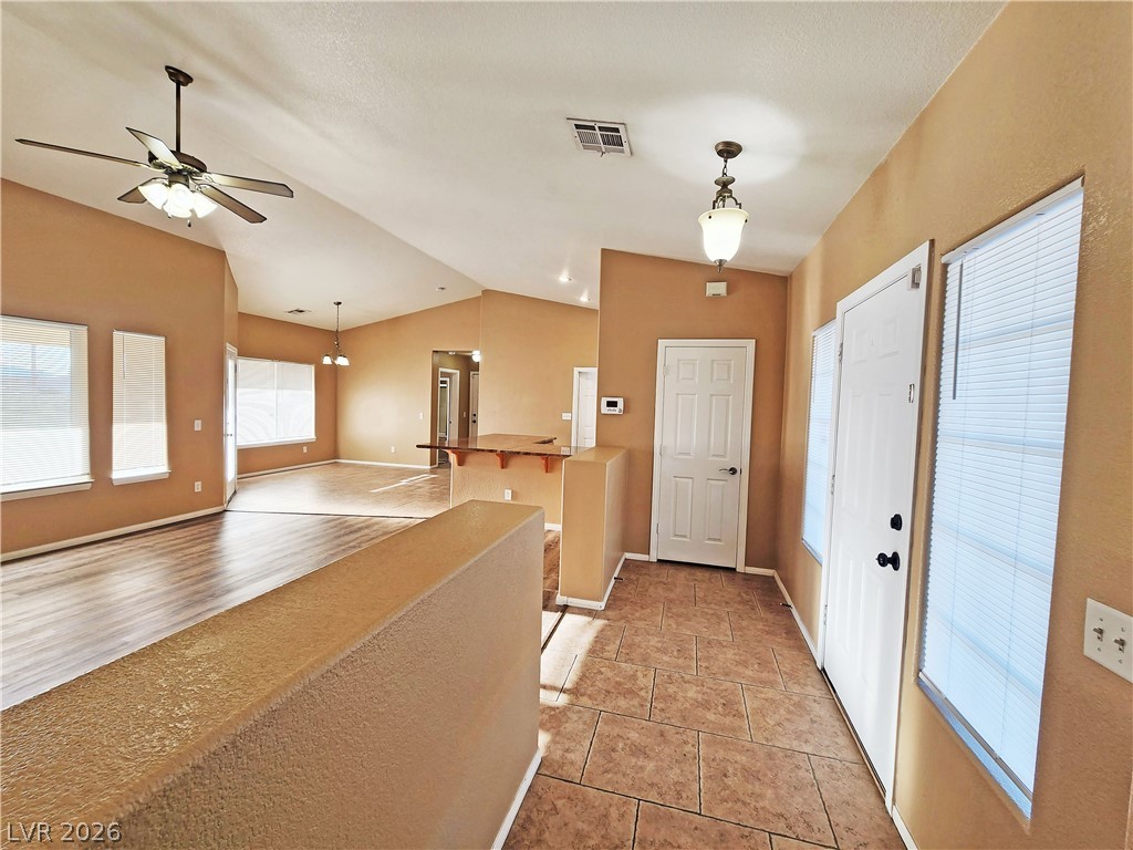 3680 Ravine Avenue Pahrump, NV 89048 - Photo 2 of 28 Entryway featuring vaulted ceiling, visible vents, baseboards, and ceiling fan