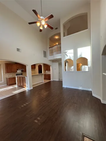 a living room with hardwood floor and a ceiling fan
