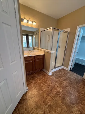 a bathroom with a tub sink and mirror