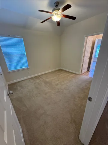 an empty room with a ceiling fan
