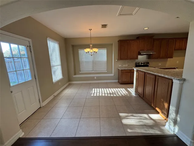 a view of a kitchen with an empty space and a window
