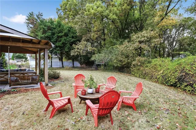 a front view of a house with a yard and potted plants