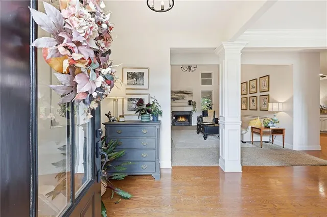 a living room with furniture and a chandelier