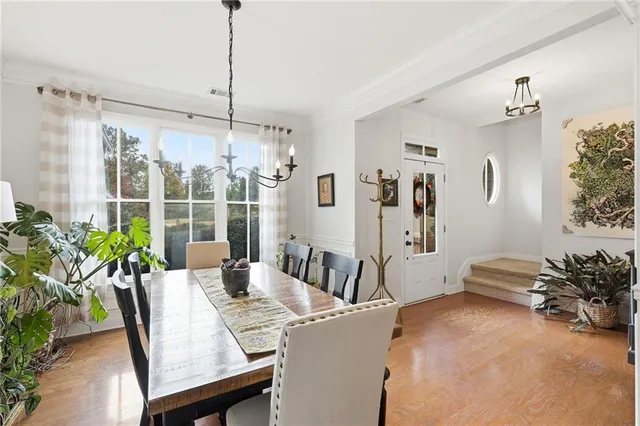 a living room with furniture a rug and a chandelier